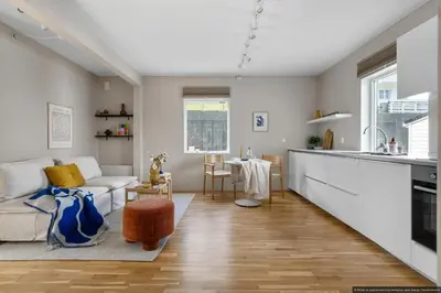a kitchen and living room with a couch and a table at Cozy Apartment near City Centre in Bergen