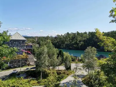 an aerial view of a house next to a lake at Haven Fortress in Lii
