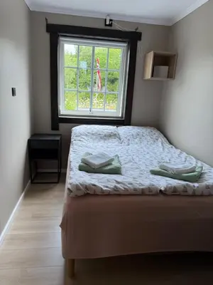a small bedroom with a bed with a window at Haven Fortress in Lii