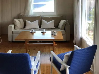 a living room with a couch and a table and chairs at 2 person holiday home in Balestrand in Balestrand