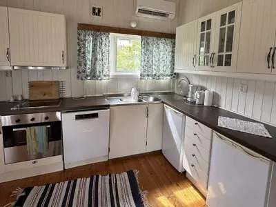 a kitchen with white cabinets and a sink at 2 person holiday home in Balestrand in Balestrand