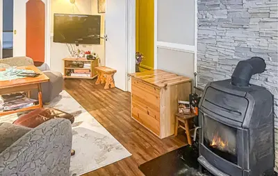 a living room with a fireplace and a television at Cozy Home In Sparbu With Wifi in Sparbu