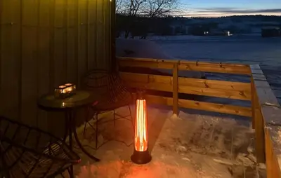 a light on a table next to a fence at Cozy Home In Sparbu With Wifi in Sparbu