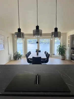 a dining room with a table and chairs at Large house by the sea in Bergen
