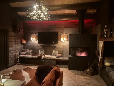 a living room with a couch and a fireplace at Historical & exclusive cabin - Ski in-out - 18 people in Nord-Fron