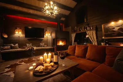 a living room with a couch and candles on a table at Historical & exclusive cabin - Ski in-out - 18 people in Nord-Fron