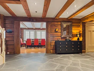 a dining room with a table and red chairs at Exclusive cottage Jacuzzi View Ski in out in Aurdal