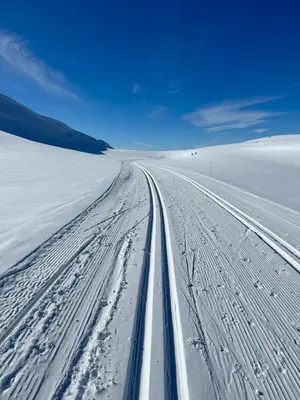 a road in the middle of a snow covered field at Exclusive cottage Jacuzzi View Ski in out in Aurdal