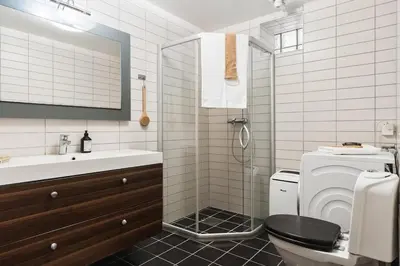 a bathroom with a shower and a toilet and a sink at Bright and cozy 2-bedroom apartment in Bergen