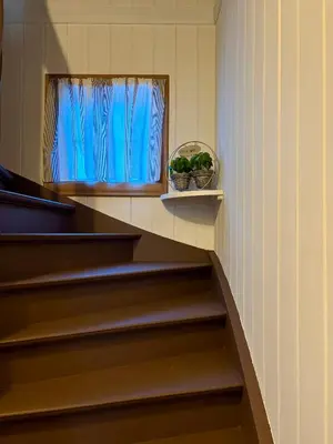 a staircase with a window and a bowl of plants at Valhalla Hytte in Oppdal