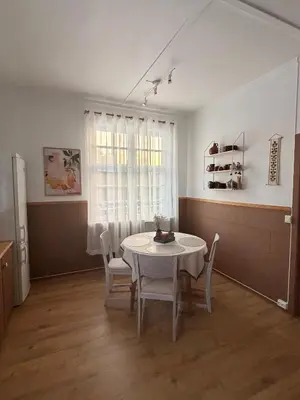a dining room with a white table and chairs at Valhalla Hytte in Oppdal
