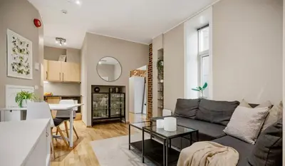 a living room with a couch and a table at Central and cozy apartment in Bergen City Center in Bergen