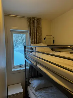 a bedroom with two bunk beds and a window at Oppheim Mountain Resort - Pool, Sauna & Lake! in Vossevangen