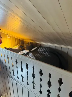 a bed in a bunk room with a railing at Luxury cabin in the mountains, with sauna and steam shower in Geilo