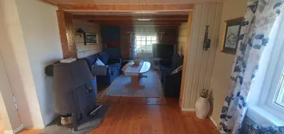 a living room with a couch and a table at Sunset Cabin in Ålesund