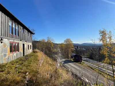 a building on a hill next to a train station at Peis, Utsikt Og 200 M Til Bakken in Beitostøl