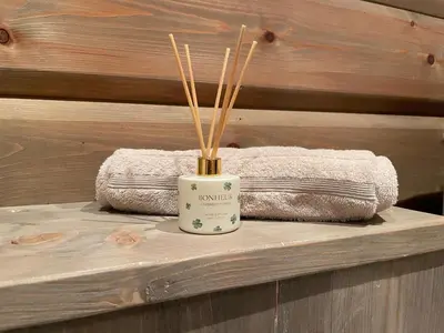 a table with two towels and a vase with sticks at Hjemmekoselig Hytte Ved Øyangen in Beitostøl