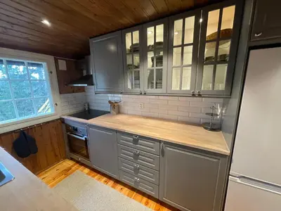 a kitchen with gray cabinets and a counter top at Hjemmekoselig Hytte Ved Øyangen in Beitostøl