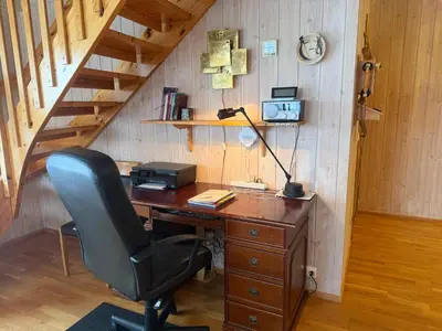 an office with a desk with a lamp and a chair at Koselig Leilighet Med Flott Utsikt in Beitostøl