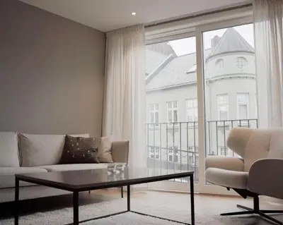 a living room with a couch and a table and a window at Leilighet 101 og 102 i Brunholmgata 9 in Ålesund