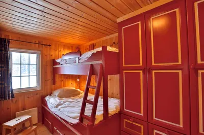 a bedroom with a bunk bed in a cabin at Relax And Unwind At Slettero-A Cozy Family Getaway in Beitostøl