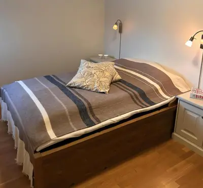 a bed with a blanket and a pillow on it at Familievennlig Leilighet Med 7 Sengeplasser in Beitostøl