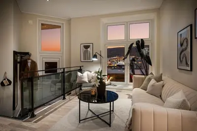 a living room with a couch and a table at Nice apartment near the city center! in Bergen