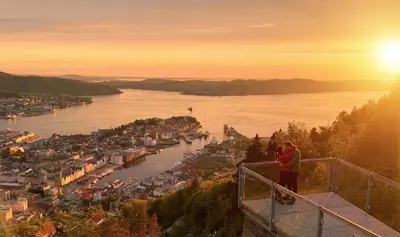 a couple standing on top of a tower overlooking a river at Nice apartment near the city center! in Bergen