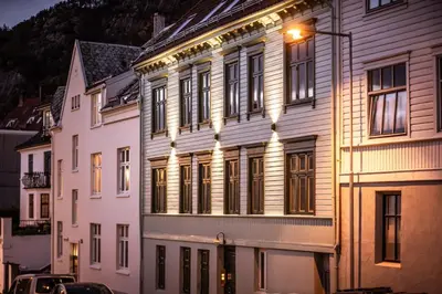 a building with a light on the side of it at Fantastic village apartment in Bergen in Bergen