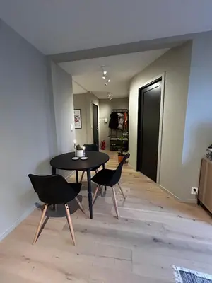 a dining room with a black table and chairs at Fantastic village apartment in Bergen in Bergen
