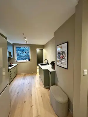 an empty kitchen with a sink and a window at Fantastic village apartment in Bergen in Bergen