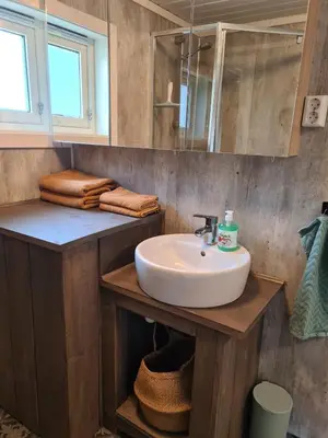 a bathroom with a sink and a mirror at Nordfjordcabins BLUE in Utvik