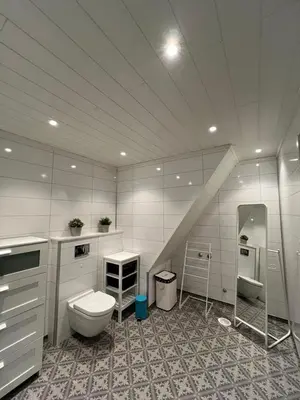 a bathroom with a toilet and a sink at Leilighet i paradisbukta in Torvikbukt