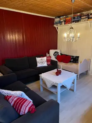 a living room with a couch and a table at Leilighet i paradisbukta in Torvikbukt