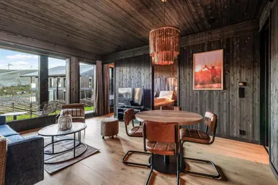 a living room with a table and chairs at Kikut Alpin Lodge 2102 in Hol