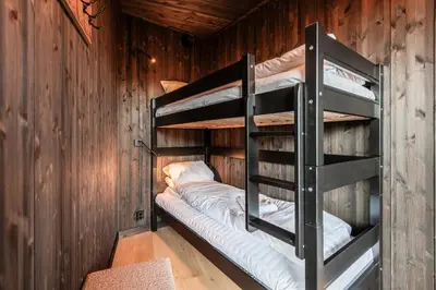 a bunk bed room with two bunk beds in a cabin at Kikut Alpin Lodge 2102 in Hol