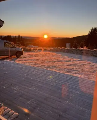 a car parked in a parking lot at sunset at Mountain cabin in Lillehammer in Lillehammer