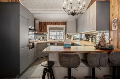 a kitchen with a island with two bar stools at Trysilfjell hytteomrade 589 in Hovi