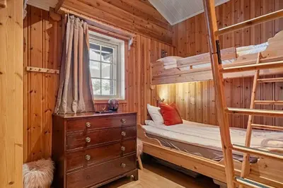 a bedroom with bunk beds in a log cabin at Trysilfjell hytteomrade 589 in Hovi