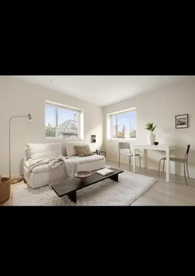 a living room with a white couch and a table at Bright and modern apartment close to the city center! 2 bedroom in Bergen