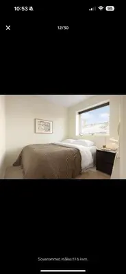 a picture of a bedroom with a bed and a window at Bright and modern apartment close to the city center! 2 bedroom in Bergen