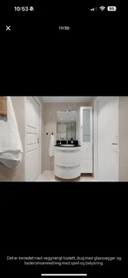 a bathroom with white cabinets and a white sink at Bright and modern apartment close to the city center! 2 bedroom in Bergen