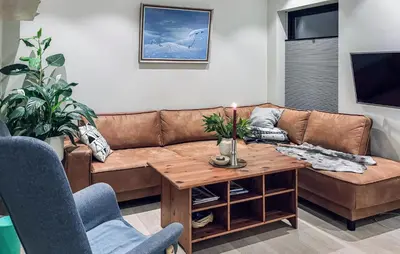 a living room with a brown couch and a table at 3 Bedroom Beautiful Apartment In Voss in Vossevangen