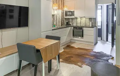 a kitchen with a wooden table and chairs at Amazing Apartment In Bjorli With Wifi in Bjorli