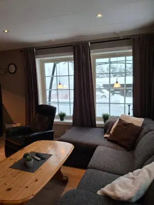 a living room with a couch and a table at Bjørgebu Camping AS in Nord-Fron