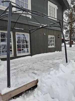 a house covered in snow with a gazebo at Bjørgebu Camping AS in Nord-Fron