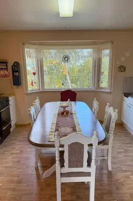 a dining room table and chairs in a kitchen at Holiday Home Stabben white House by Interhome in Aure