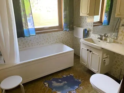 a bathroom with a tub and a sink at Holiday Home Fjordtraum by Interhome in Balestrand