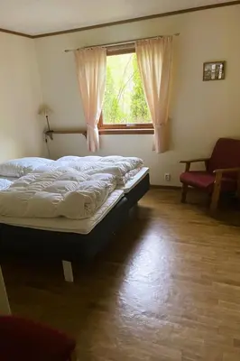 a bedroom with a bed and a window and a chair at Holiday Home Fjordtraum by Interhome in Balestrand