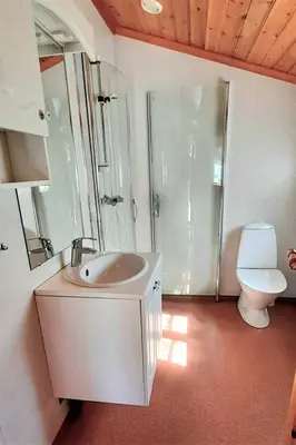 a bathroom with a sink and a shower and a toilet at Holiday Home Ein Traumstandort by Interhome in Hebnes